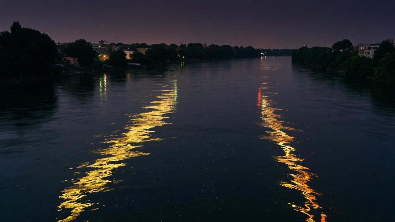 A night river with two gold reflections that do not meet