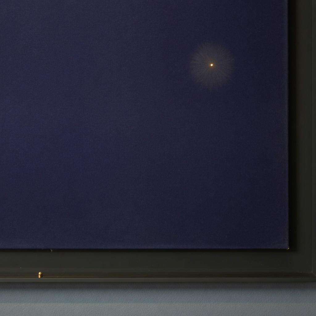 A near-void field with one distant saffron point of light
