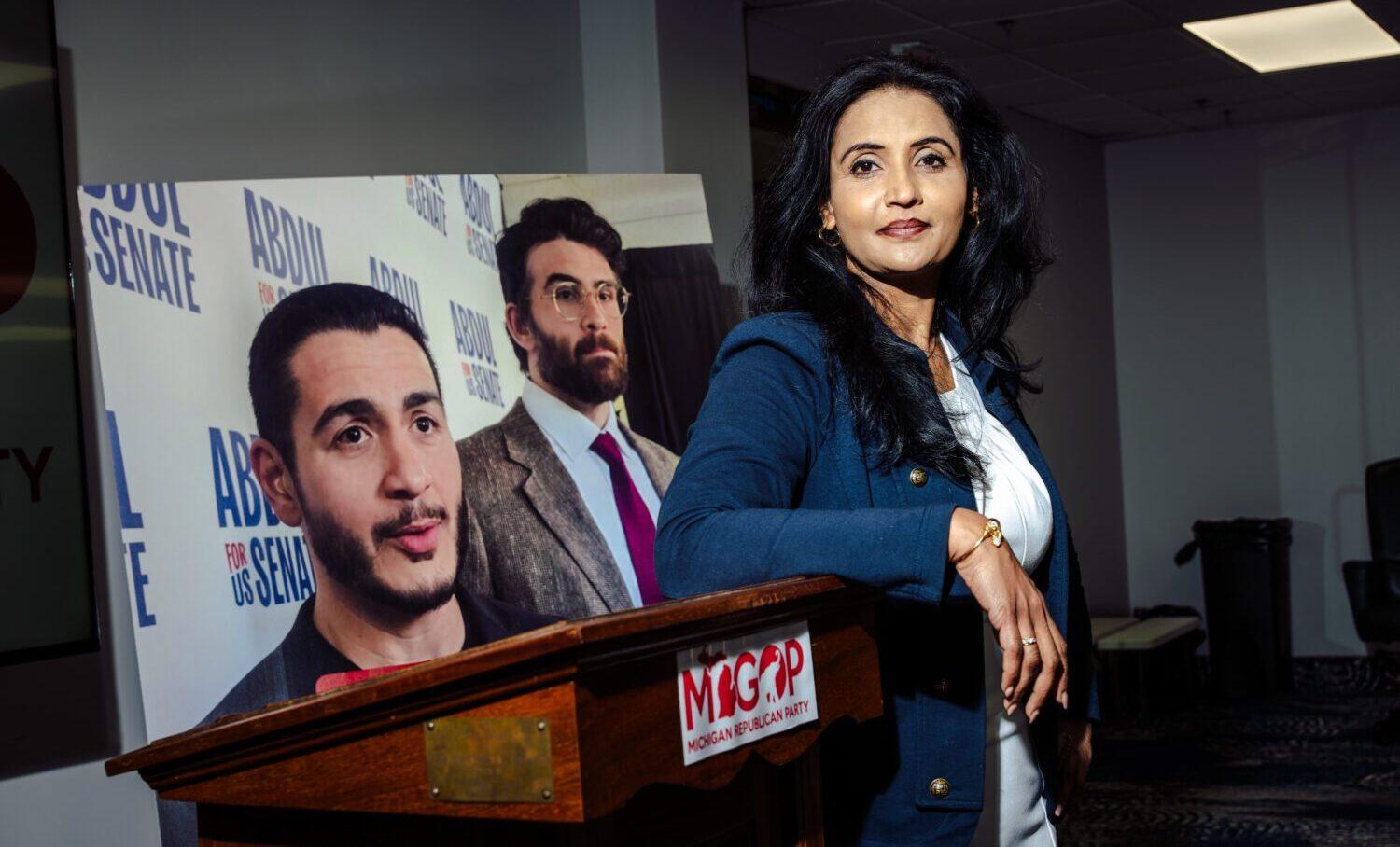 A speaker at the Michigan Republican Party podium in Troy during the Aug 28 press conference, with the state outline on the lectern
